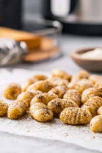 Place the seasoned gnocchi in the air fryer basket in a single layer and air fry until golden brown and crispy