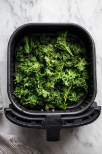 Place the seasoned kale in the air fryer basket in a single layer
