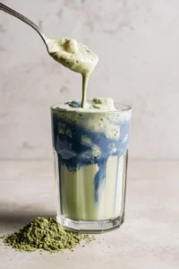 Pour blue matcha mixture into glass and top with milk