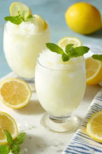 Pour the slushie into glasses and serve immediately, garnished with lemon slices or fresh mint if desired.
