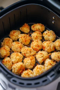 Preheat air fryer and cook cauliflower wings