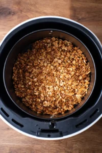 Preheat the air fryer to 320 degrees Fahrenheit and spread granola mixture evenly in the basket