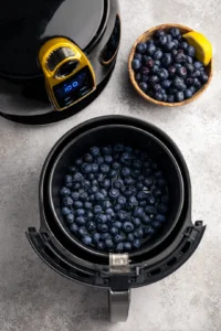 Preheat the air fryer to 350 degrees Fahrenheit, mix blueberries, honey, and lemon juice