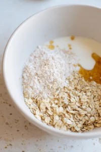 Preheat your air fryer to 320 degrees Fahrenheit and mix rolled oats, milk, honey, and baking powder