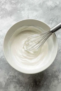 Prepare icing for cinnamon rolls by mixing icing packet with milk