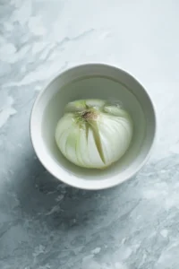 Prepare onion petals by slicing and soaking in cold water for 30 minutes
