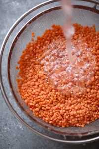 Rinse the red lentils under cold water