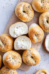 Slice mini bagels in half and scoop out some of the inside for filling