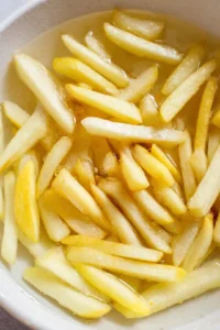 Soak cut potatoes in cold water