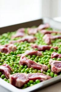 Spread the lamb and peas evenly on a sheet pan