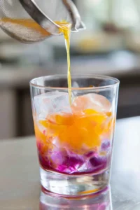 Strain mixture into a glass filled with ice and add tonic water