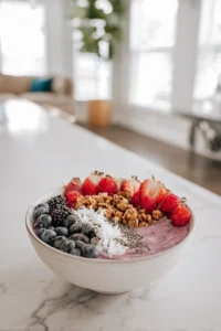 Top your smoothie bowl with fresh berries, granola, chia seeds, and coconut flakes
