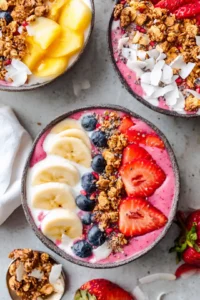 Top your smoothie bowls with granola, fresh fruits, and coconut flakes.