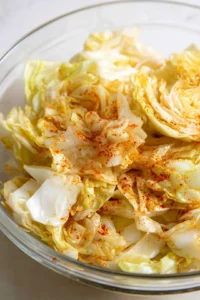 Toss cabbage chips with olive oil, salt, and paprika, then place in air fryer