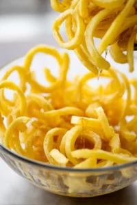 Toss frozen curly fries with olive oil until evenly coated