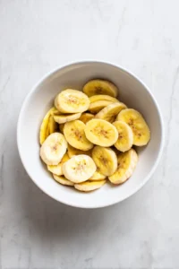 Toss sliced plantains with olive oil and salt
