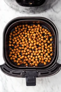 Transfer chickpeas to air fryer basket and cook until crispy and golden brown