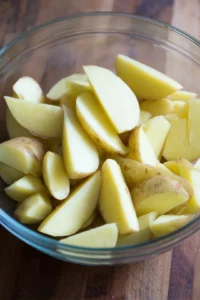 Wash and cut the potatoes into wedges