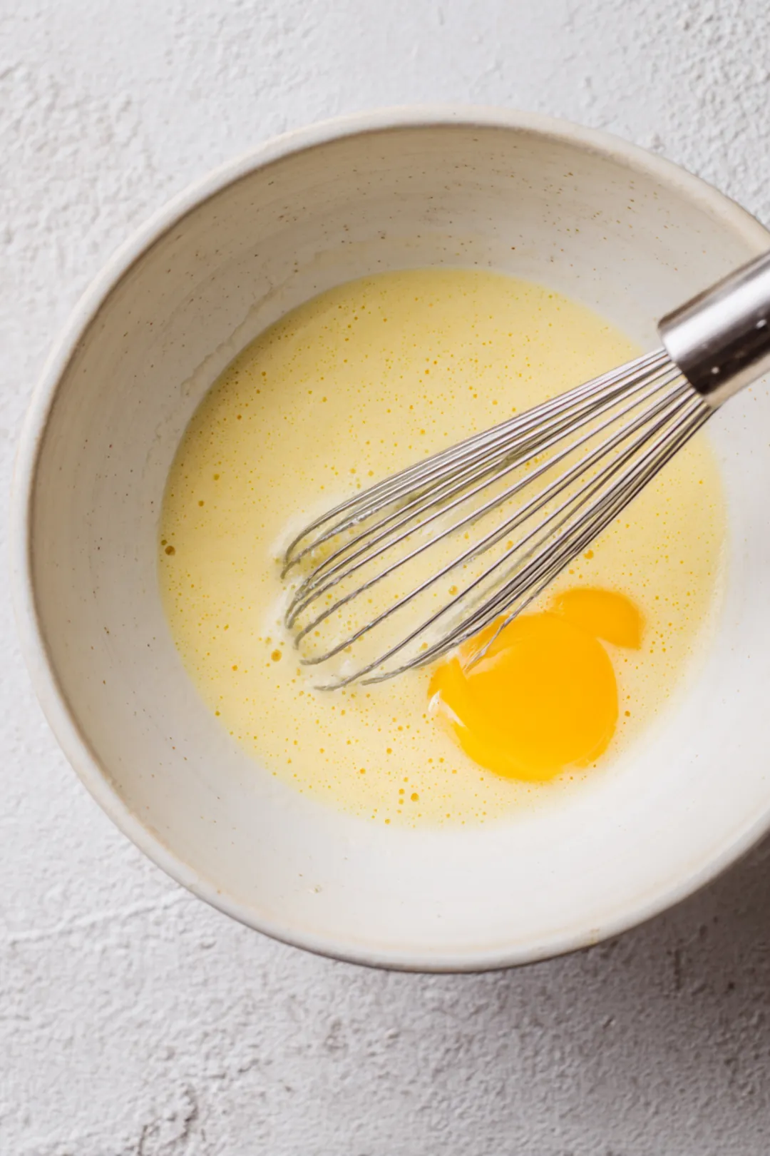 Whisk together eggs, milk, and vanilla extract in a medium bowl