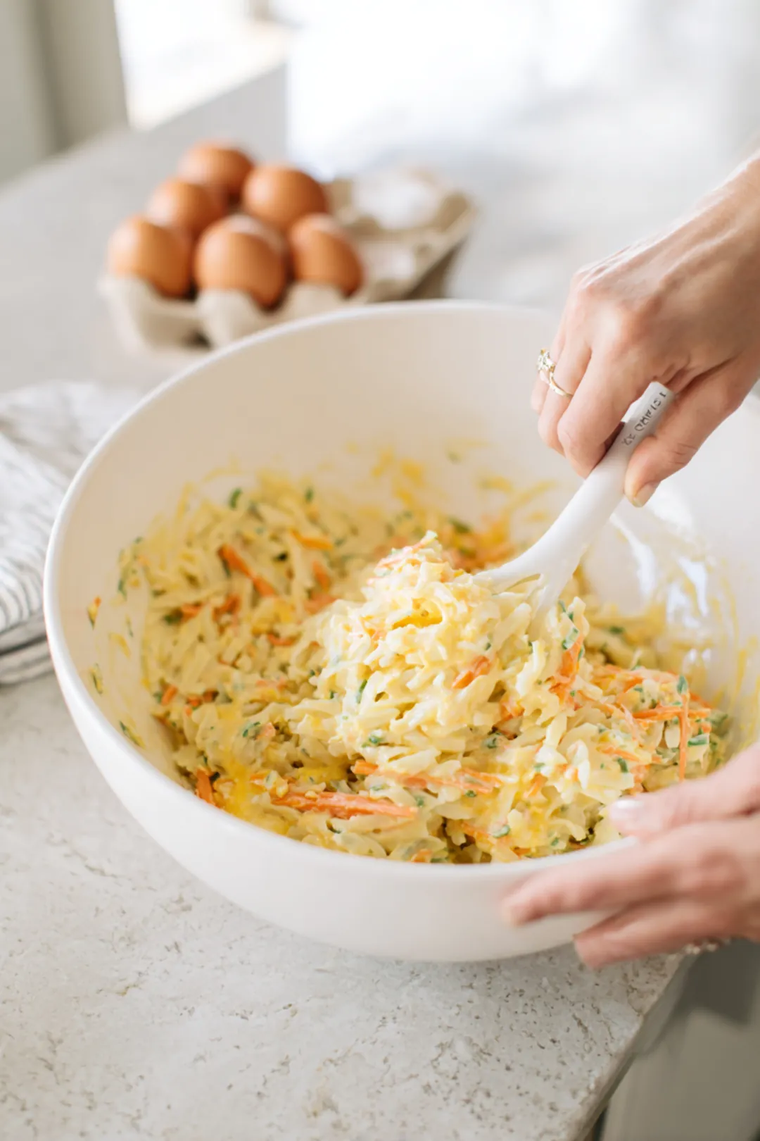 Whisk together eggs, salt, pepper, and cheese with pasta