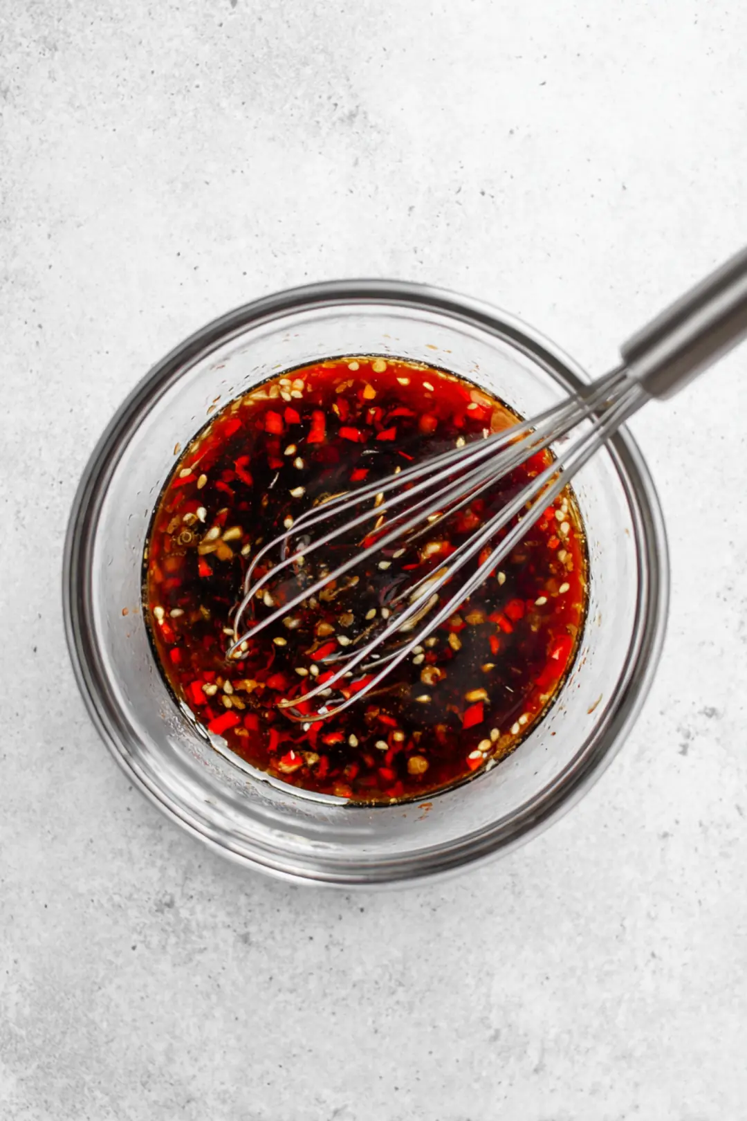 Whisk together the soy sauce, chili sauce, sesame oil, ginger, and garlic to create the sauce