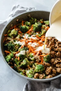 Add broccoli and carrots to the skillet and stir in the sauce