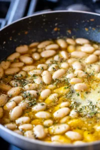 Add butter beans, vegetable broth, and herbs de Provence, let simmer for 20 minutes, allowing sauce to thicken, stir in cream and fresh basil just before serving, season with salt and pepper to taste