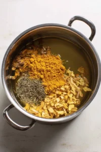 Add dried ginger and turmeric to boiling water and let it simmer