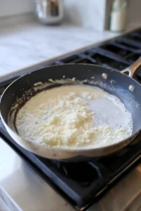 Add heavy cream and Parmesan cheese to the sauce
