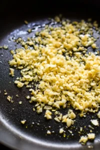 Add minced garlic to the skillet and sauté until fragrant