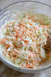 Add shredded cabbage and carrots to yogurt mixture and toss gently to coat all vegetables evenly with dressing