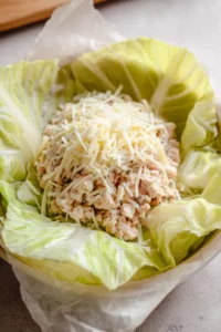 Assemble the chicken wraps in cabbage leaves