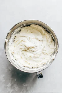 Beat cream cheese and unsalted butter until smooth, gradually add powdered sugar and vanilla extract, adjust consistency with milk as needed