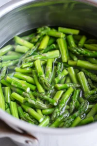 Blanch asparagus pieces until bright green and tender-crisp