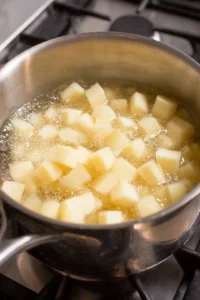 Boil cubed potatoes until fork-tender