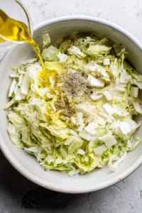 Combine chopped cabbage and parsnips with olive oil, salt, pepper, and garlic powder