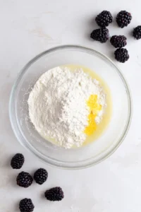 Combine dry ingredients and wet ingredients with blackberries