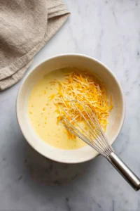 Combine eggs and milk with spaghetti and vegetables