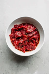 Combine gochujang and soy sauce with beef flank steak