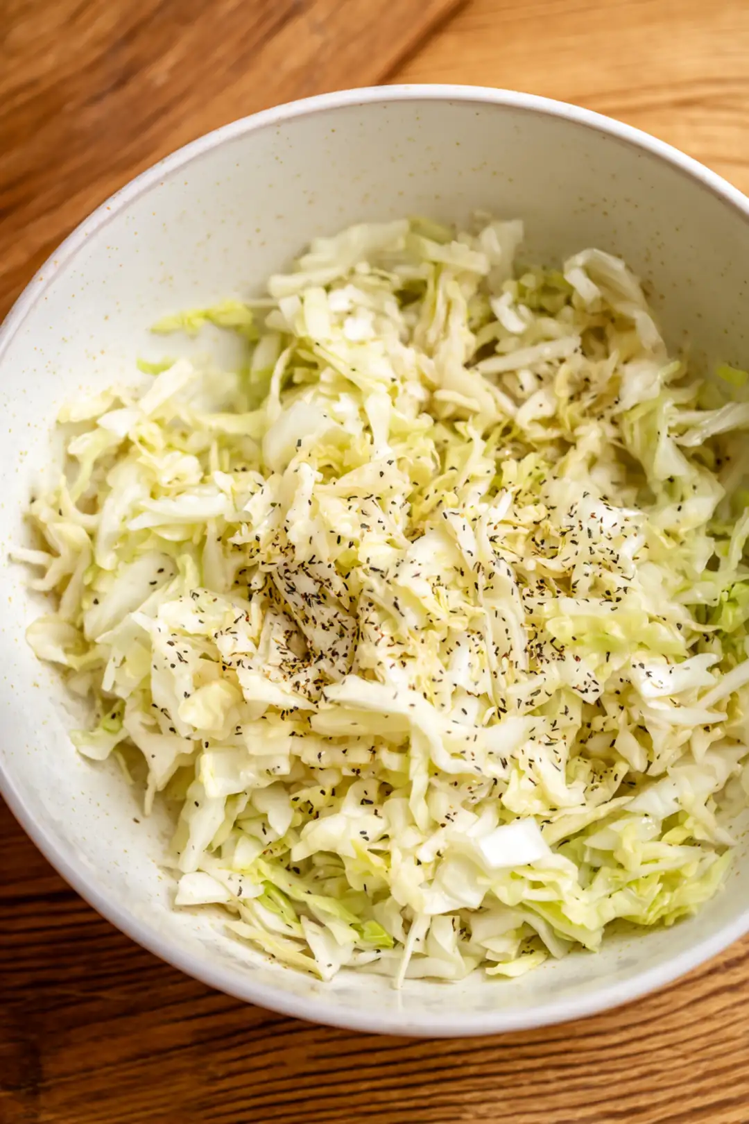 Combine grated apples and caraway seeds with cabbage