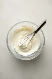 Combine Greek yogurt, apple cider vinegar, honey, salt, and black pepper in a bowl
