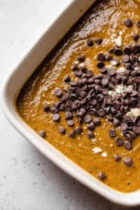 Combine mashed bananas with melted coconut oil and dry ingredients