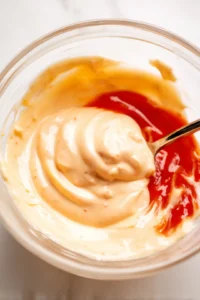 Combine mayonnaise, ketchup, and mustard to create the sauce