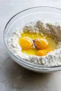 Combine melted coconut oil, eggs, and vanilla extract with dry ingredients to create a smooth batter. Pour into the baking pan and bake until a toothpick comes out clean.