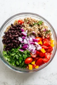 Combine quinoa and black beans with vegetables