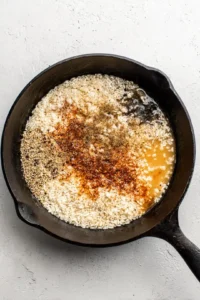 Combine rice, water, and spices in the skillet and bring to a boil