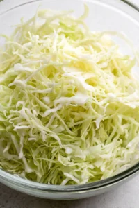 Combine shredded cabbage and salt in a large bowl and massage until softened