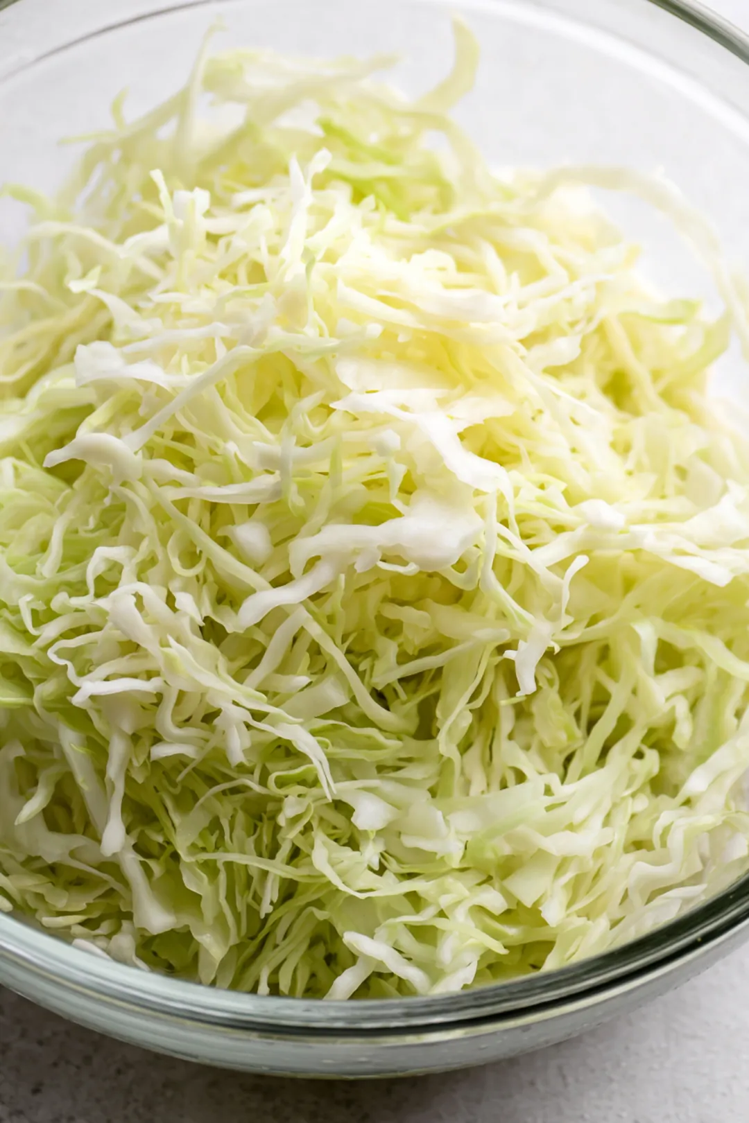 Combine shredded cabbage and salt in a large bowl and massage until softened
