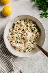 Combine shredded chicken, Greek yogurt, Caesar dressing, lemon juice, and parsley in a bowl.