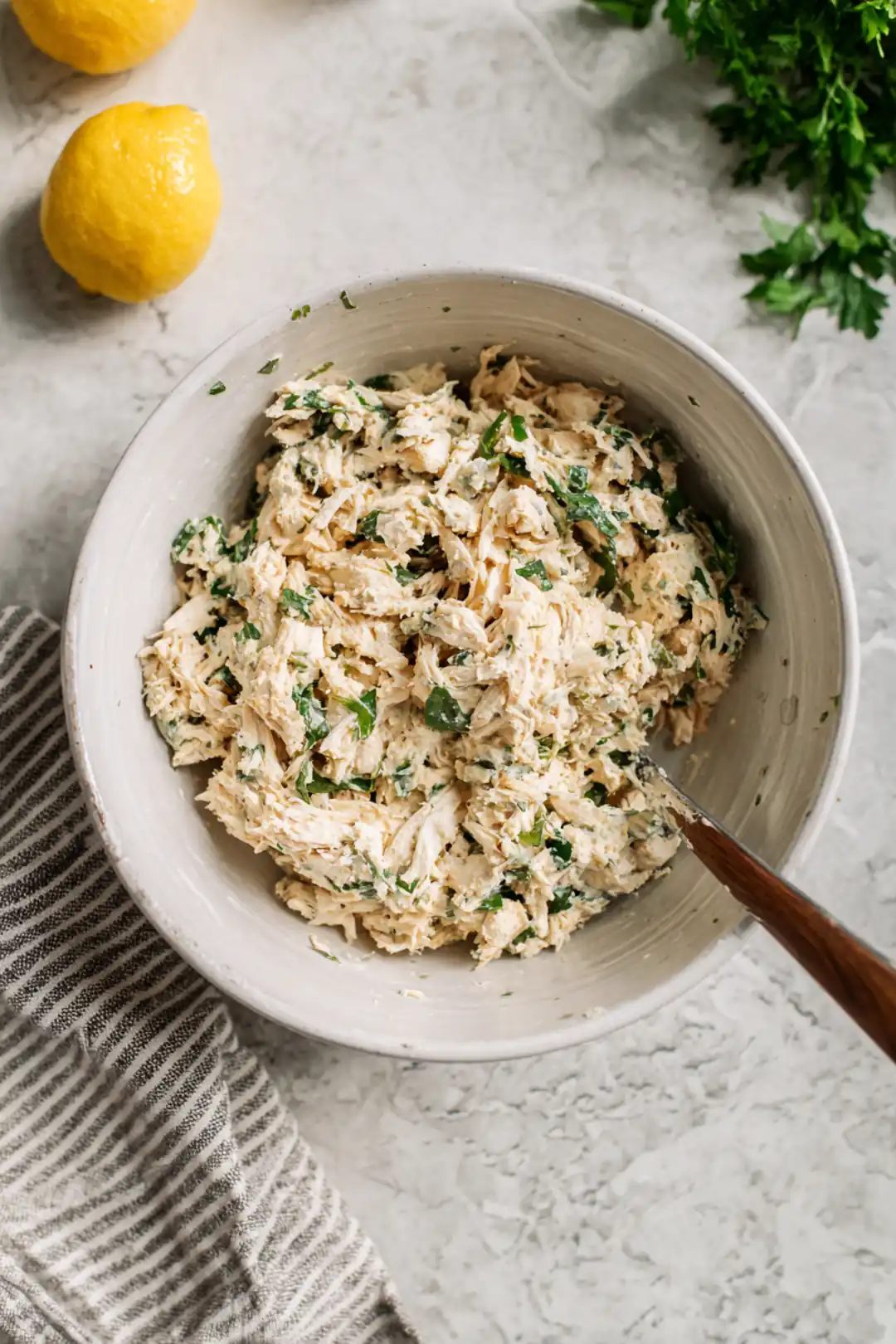 Combine shredded chicken, Greek yogurt, Caesar dressing, lemon juice, and parsley in a bowl.
